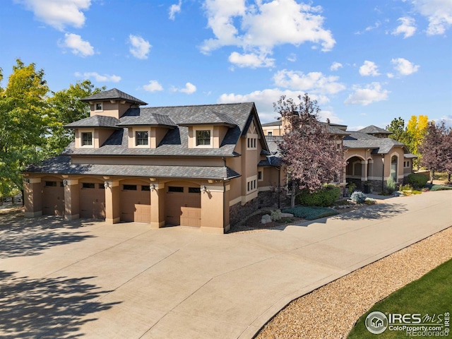 863 Riparian Way, Fort Collins, CO 80524 - view of front facade with driveway, stucco siding, a garage, and a high end roof