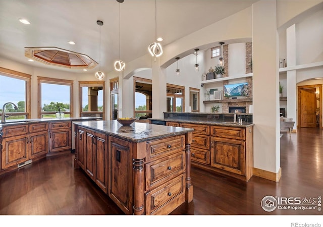 863 Riparian Way, Fort Collins, CO 80524 - kitchen with dark wood finished floors, a fireplace, healthy amount of natural light, and recessed lighting
