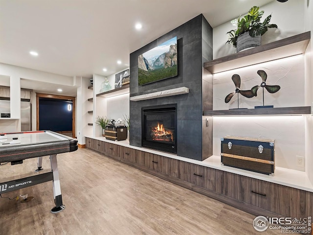 863 Riparian Way, Fort Collins, CO 80524 - rec room with a large fireplace, wood finished floors, and recessed lighting