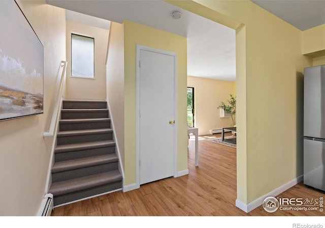 705 E Drake Rd Unit 40, Fort Collins, CO 80525 - stairs featuring wood finished floors and a baseboard heating unit
