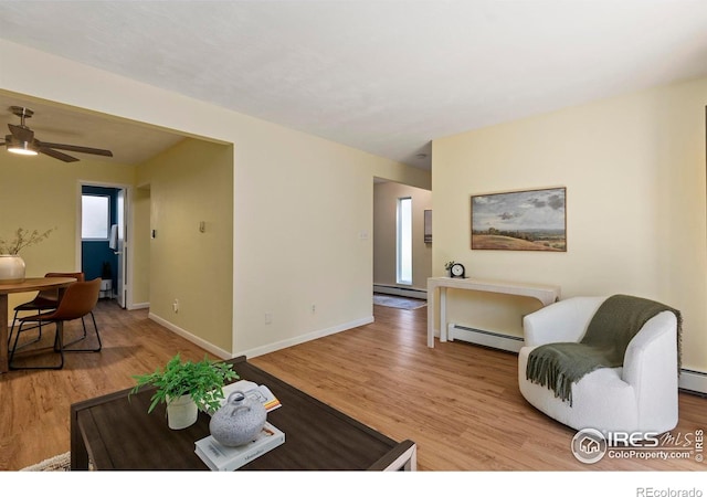 705 E Drake Rd Unit 40, Fort Collins, CO 80525 - living room featuring a baseboard heating unit, baseboard heating, light wood-style floors, and ceiling fan