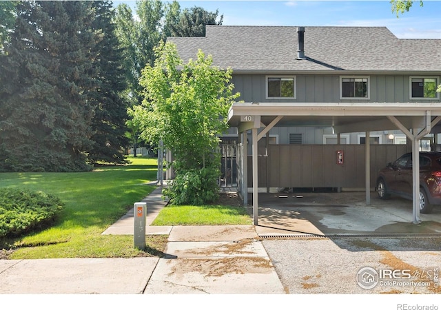 705 E Drake Rd Unit 40, Fort Collins, CO 80525 - townhome / multi-family property featuring roof with shingles, a front lawn, and covered parking
