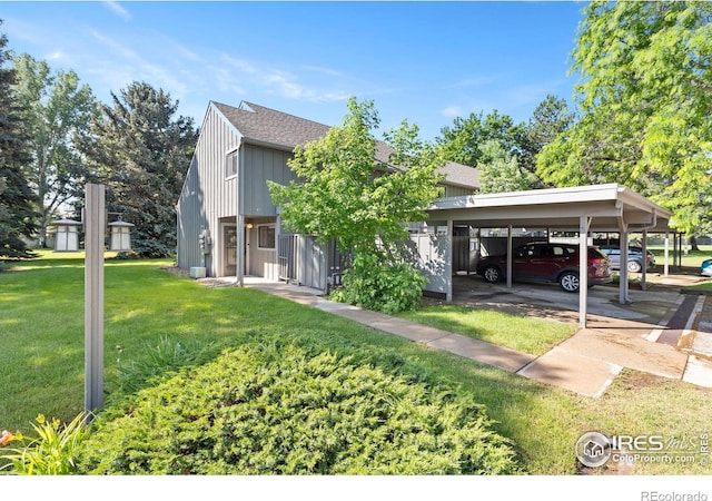 705 E Drake Rd Unit 40, Fort Collins, CO 80525 - view of front of home featuring a front yard, board and batten siding, a shingled roof, and covered parking