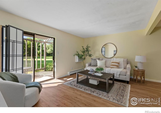 705 E Drake Rd Unit 40, Fort Collins, CO 80525 - living area featuring wood finished floors and a baseboard radiator
