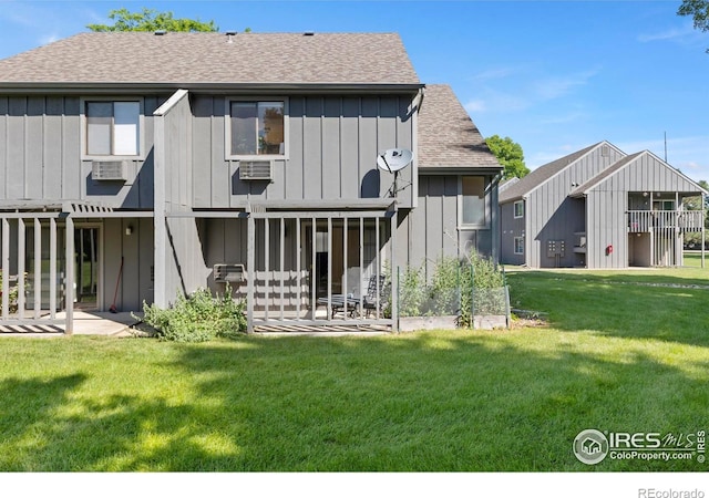 705 E Drake Rd Unit 40, Fort Collins, CO 80525 - back of house with board and batten siding, roof with shingles, a yard, and a patio area