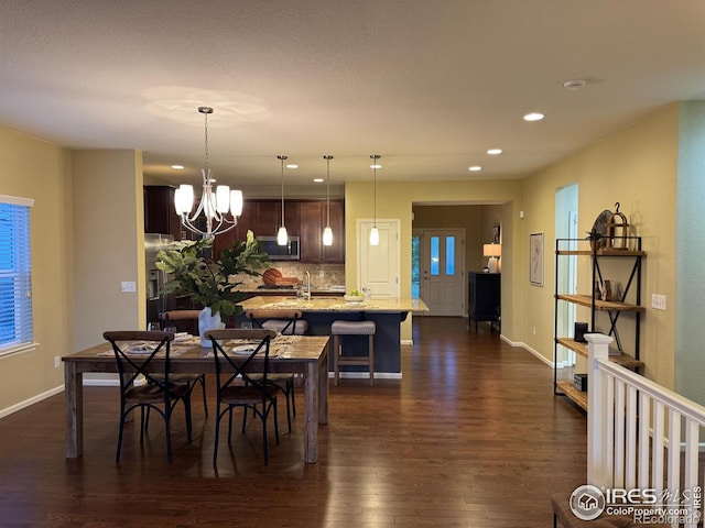 306 Baja Dr, Windsor, CO 80550 - dining room with dark wood finished floors, recessed lighting, and a chandelier