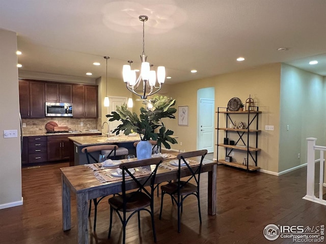 306 Baja Dr, Windsor, CO 80550 - dining area with recessed lighting, dark wood-style flooring, and a chandelier