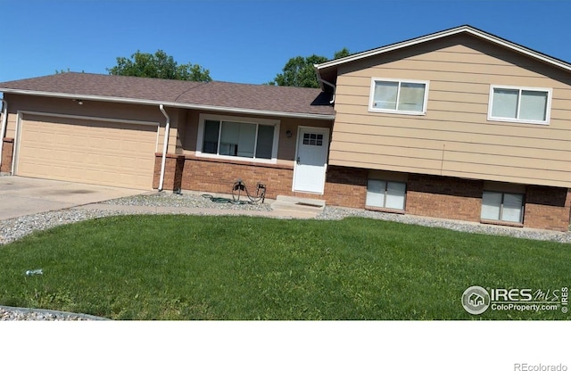 3200 Claremont Ave, Evans, CO 80620 - split level home featuring brick siding, a front lawn, an attached garage, and driveway