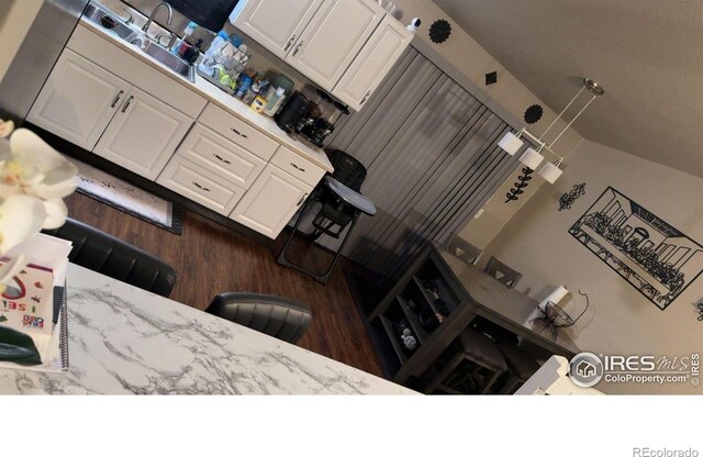 3200 Claremont Ave, Evans, CO 80620 - kitchen featuring wood finished floors and white cabinets