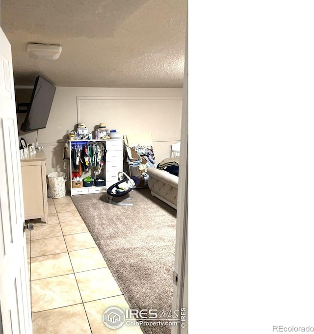 3200 Claremont Ave, Evans, CO 80620 - corridor with tile patterned flooring and a textured ceiling