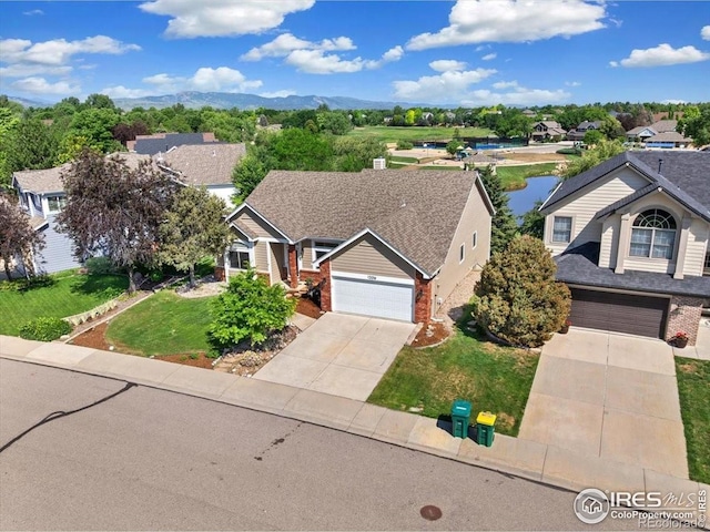 1206 Canvasback Ct, Fort Collins, CO 80525 - view of front of property with concrete driveway, brick siding, a front lawn, and a residential view