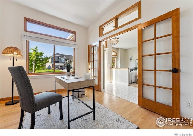 1206 Canvasback Ct, Fort Collins, CO 80525 - office featuring plenty of natural light, wood finished floors, a chandelier, and french doors