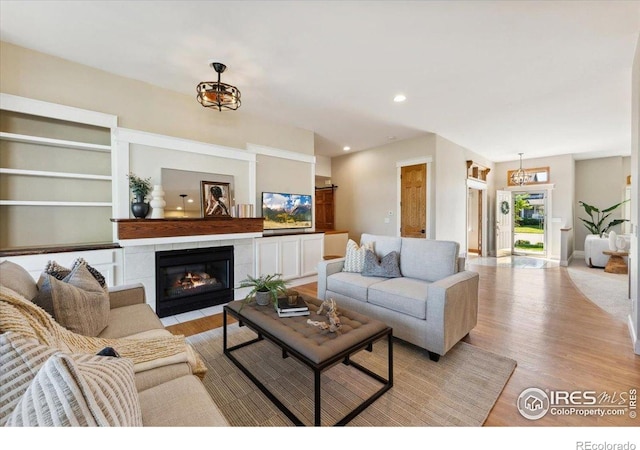 1206 Canvasback Ct, Fort Collins, CO 80525 - living room with light wood finished floors, a fireplace, and recessed lighting