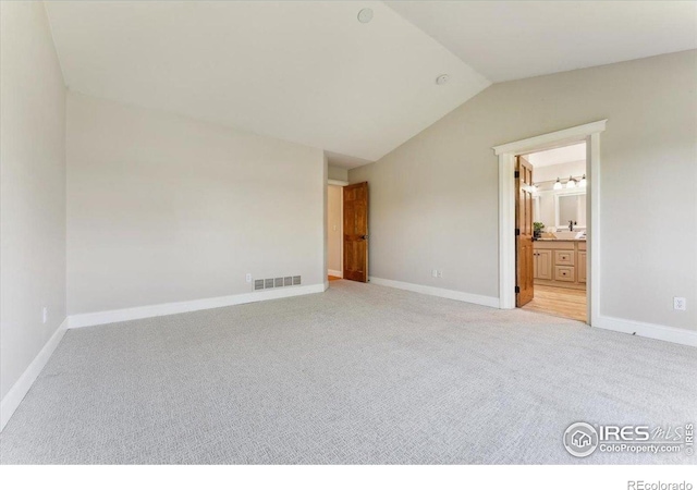 1206 Canvasback Ct, Fort Collins, CO 80525 - unfurnished bedroom featuring light carpet, lofted ceiling, and ensuite bathroom