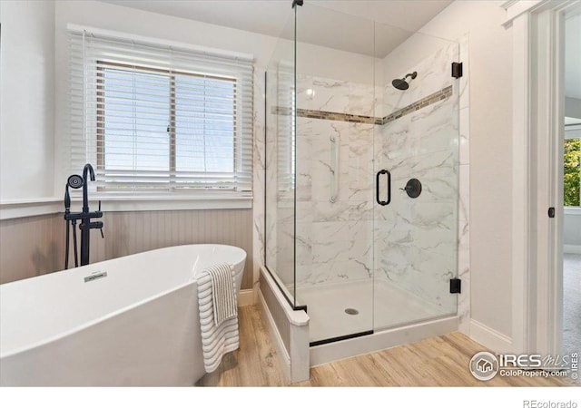 1206 Canvasback Ct, Fort Collins, CO 80525 - bathroom featuring wood finished floors, a freestanding bath, and a marble finish shower