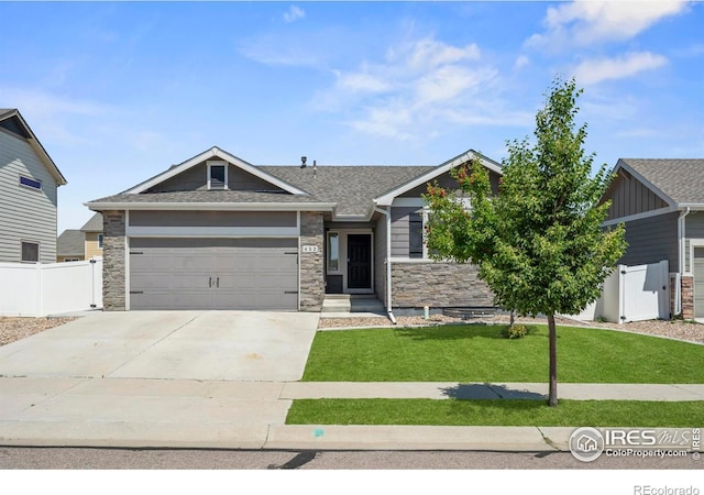 452 Mt Sherman Ave, Severance, CO 80550 - craftsman-style home with an attached garage, stone siding, driveway, and a shingled roof