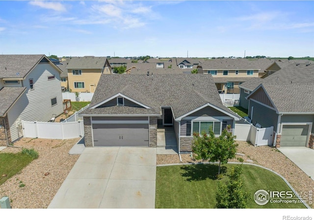 452 Mt Sherman Ave, Severance, CO 80550 - view of front of property with stone siding, driveway, a gate, and a residential view