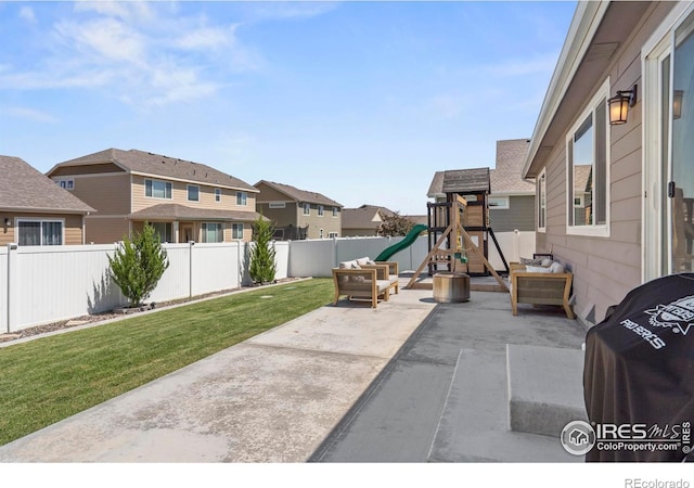 452 Mt Sherman Ave, Severance, CO 80550 - fenced backyard featuring a playground, a residential view, a patio area, and an outdoor living space