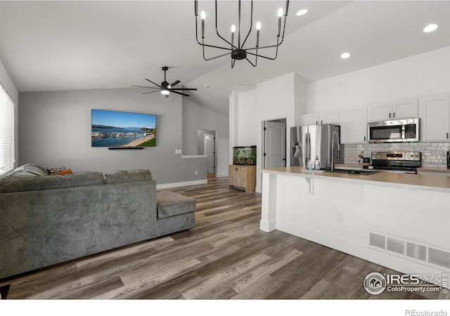 452 Mt Sherman Ave, Severance, CO 80550 - kitchen with appliances with stainless steel finishes, open floor plan, white cabinetry, recessed lighting, and high vaulted ceiling