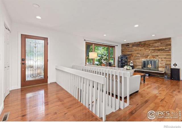 7261 Mount Meeker Rd, Longmont, CO 80503 - entryway featuring wood finished floors, recessed lighting, and a stone fireplace