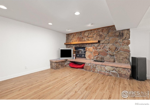 7261 Mount Meeker Rd, Longmont, CO 80503 - living area with wood finished floors, a wood stove, and recessed lighting