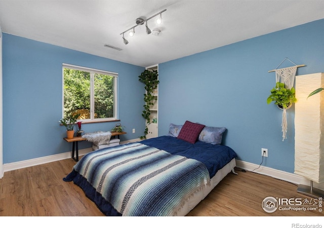 7261 Mount Meeker Rd, Longmont, CO 80503 - bedroom with wood finished floors and track lighting