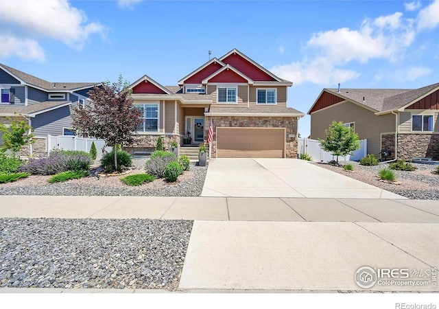 2597 Elk Ln, Johnstown, CO 80534 - craftsman-style house featuring stone siding, driveway, and a garage
