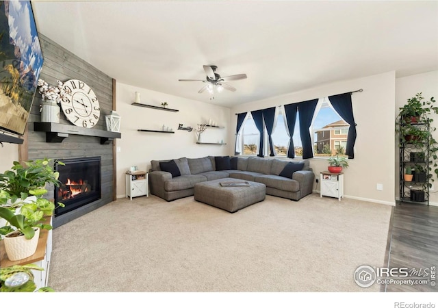 6504 Zimmerman Lake Rd, Timnath, CO 80547 - living room featuring a large fireplace, ceiling fan, and carpet