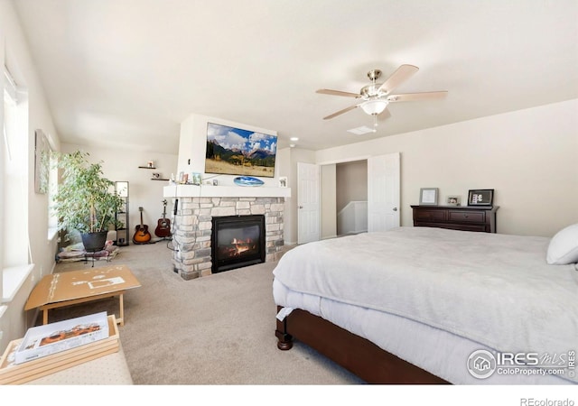 6504 Zimmerman Lake Rd, Timnath, CO 80547 - carpeted bedroom featuring a stone fireplace