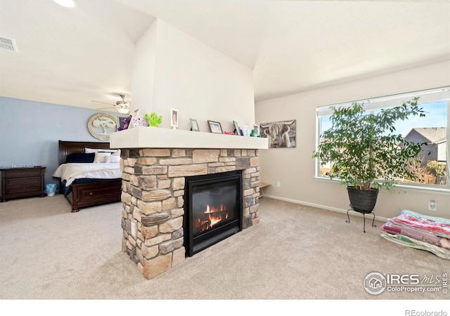 6504 Zimmerman Lake Rd, Timnath, CO 80547 - carpeted living room featuring ceiling fan and a stone fireplace