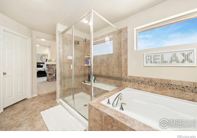 6504 Zimmerman Lake Rd, Timnath, CO 80547 - bathroom featuring connected bathroom, a garden tub, a shower stall, and tile patterned flooring