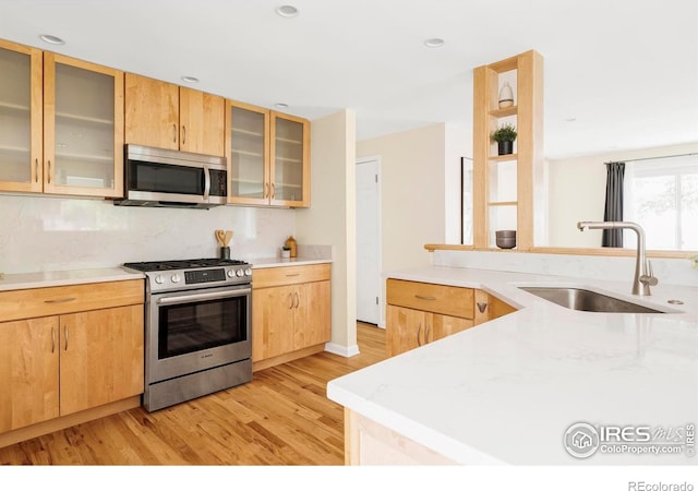 2085 Alpine Dr, Boulder, CO 80304 - kitchen featuring appliances with stainless steel finishes, light wood-type flooring, backsplash, glass insert cabinets, and light brown cabinets