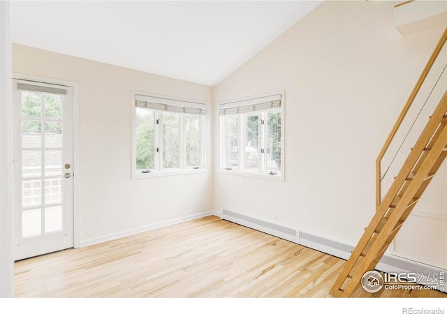 2085 Alpine Dr, Boulder, CO 80304 - spare room featuring wood finished floors, lofted ceiling, and a baseboard radiator