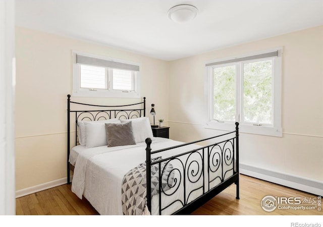 2085 Alpine Dr, Boulder, CO 80304 - bedroom featuring multiple windows, wood finished floors, and baseboard heating