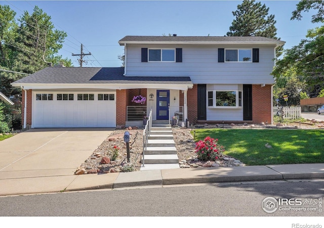1590 Findlay Way, Boulder, CO 80305 - view of front of house featuring a garage, driveway, brick siding, and a front lawn