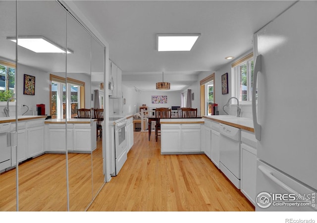 1590 Findlay Way, Boulder, CO 80305 - kitchen with white appliances, light wood finished floors, a peninsula, and white cabinetry