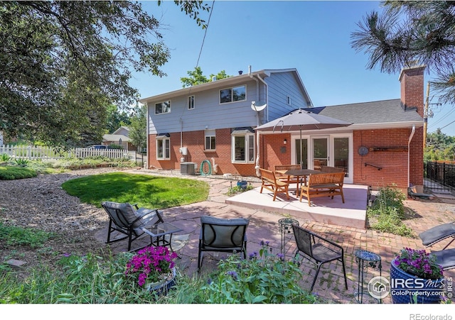 1590 Findlay Way, Boulder, CO 80305 - back of house featuring brick siding, a patio, a fenced backyard, and a chimney