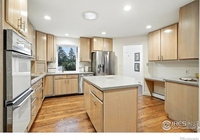 2433 Linden Dr, Boulder, CO 80304 - kitchen with appliances with stainless steel finishes, light brown cabinetry, light wood-style flooring, light countertops, and recessed lighting