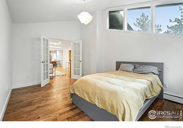 2433 Linden Dr, Boulder, CO 80304 - bedroom with french doors, wood finished floors, baseboard heating, and vaulted ceiling