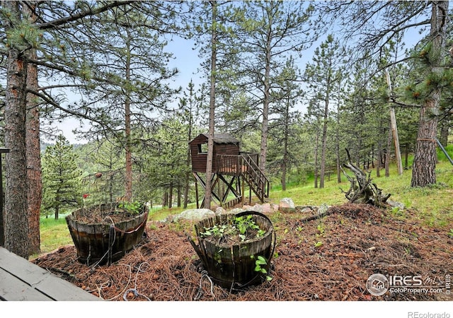 2433 Linden Dr, Boulder, CO 80304 - view of yard with a storage unit and a forest view