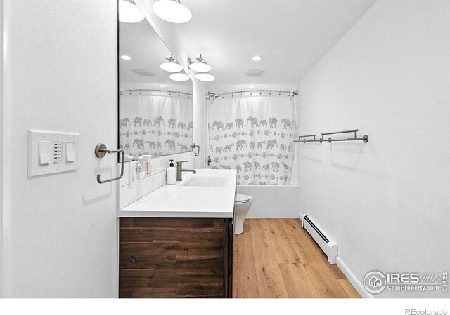 2433 Linden Dr, Boulder, CO 80304 - full bathroom with a baseboard radiator, vanity, wood finished floors, recessed lighting, and shower / tub combo