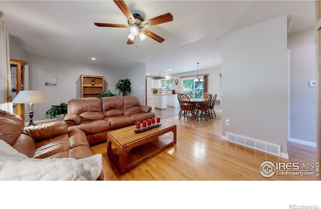 1112 E 16th St, Loveland, CO 80538 - living area featuring a ceiling fan, light wood finished floors, and recessed lighting