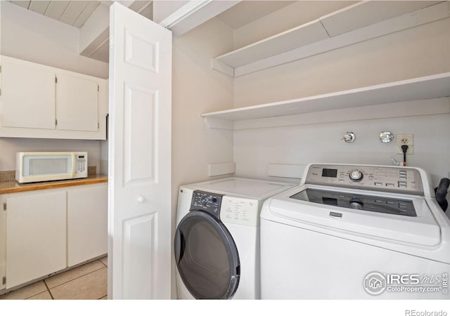 1731 Springmeadows Ct Unit A, Fort Collins, CO 80525 - laundry area with washer and clothes dryer and light tile patterned flooring