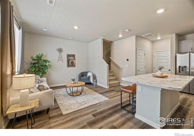 620 Apache Trl Unit 2, Ault, CO 80610 - living room featuring stairway, wood finished floors, and recessed lighting