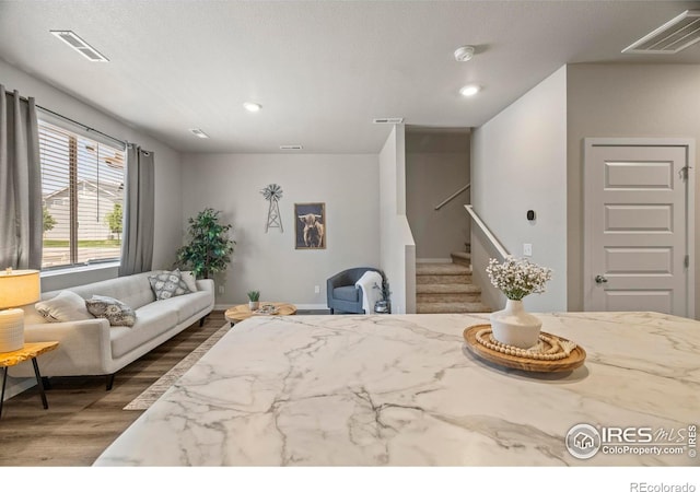 620 Apache Trl Unit 2, Ault, CO 80610 - living area with wood finished floors, stairs, and recessed lighting
