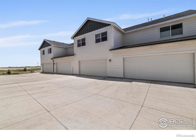 620 Apache Trl Unit 2, Ault, CO 80610 - view of front of home with an attached garage, driveway, and board and batten siding