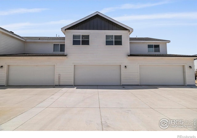 620 Apache Trl Unit 2, Ault, CO 80610 - view of front of house with a garage, concrete driveway, and board and batten siding