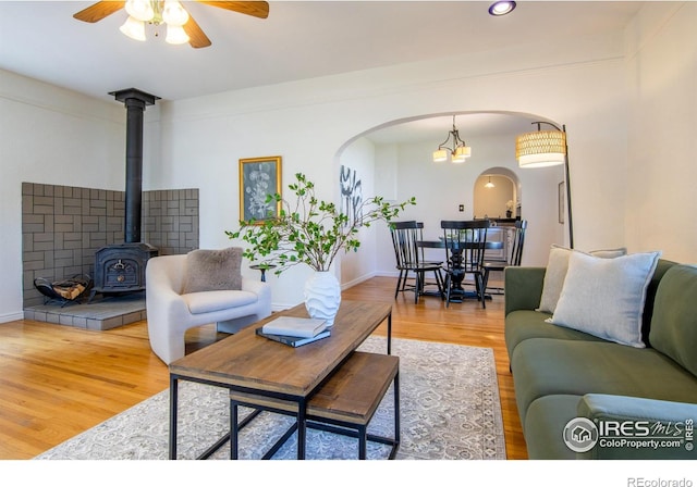 403 W Cannon St, Lafayette, CO 80026 - living room with arched walkways, a wood stove, wood finished floors, ceiling fan, and recessed lighting
