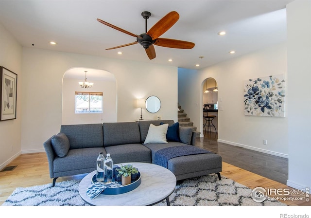 403 W Cannon St, Lafayette, CO 80026 - living room featuring arched walkways, recessed lighting, ceiling fan, wood finished floors, and stairway