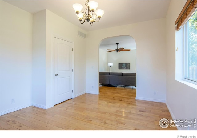403 W Cannon St, Lafayette, CO 80026 - spare room with arched walkways, light wood-type flooring, a chandelier, and a ceiling fan